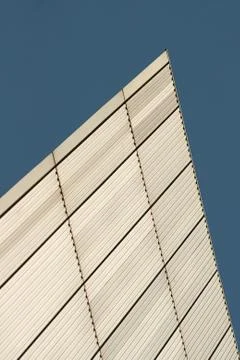 Lines and rectangles texture formed on white metal wall of building with blue Stock Photos