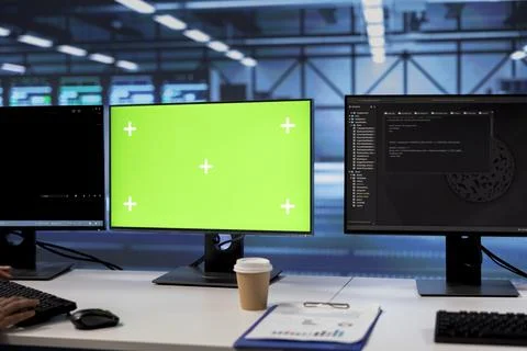 Lines of code running on green screen computers in data center Stock Photos
