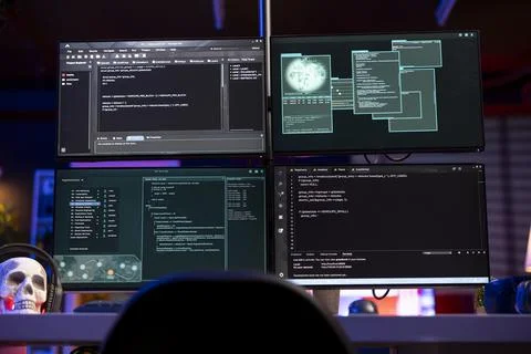 Lines of code running on PC in empty underground lair used by hacker 스톡 사진