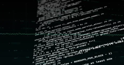 Lines of computer code are displayed on dark screen with a greenish hue 스톡 사진