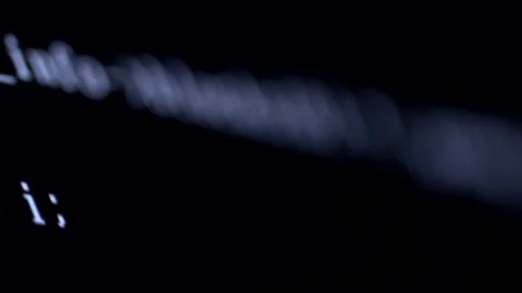 Lines of computer code being generated against a black background Stock Footage 92525217