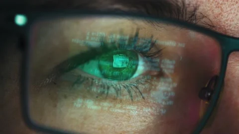 Lines of computer code reflected in the glasses of a female programmer. Close-up Stock Footage 234188020