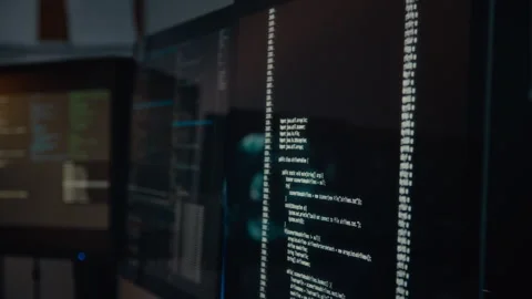 Lines of Computer Code Running on Black Screen in Dark Control Room Stock Footage 288790603