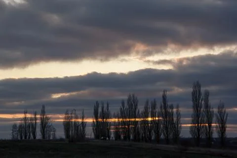 Lines of dramatic clouds at sunset, autumn Stock Photos