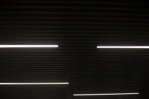 Lines in the interior. Light sources in the dark. Glowing lines. Stock Photos