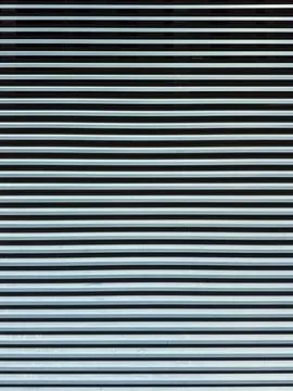 Lines of metal create a pattern in a commercial space during daytime hours Stock Photos
