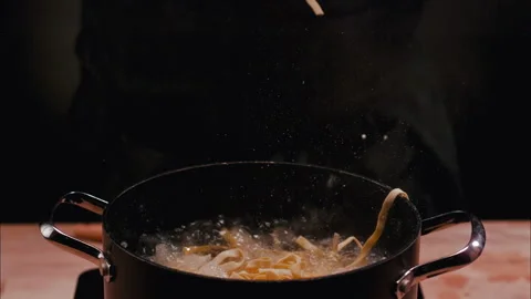 Linguini dropped in a Pot with hot boiling Water Stock Footage 254909599