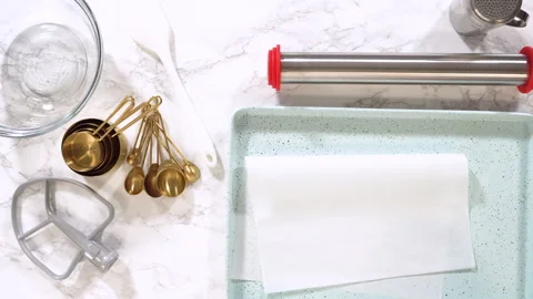 Lining Turquoise Baking Tray with Parchment Paper Stock Footage 320570548