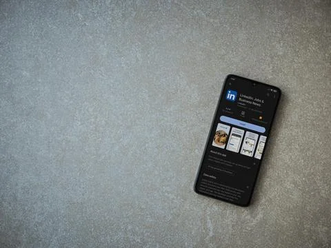 LinkedIn app play store page on smartphone on ceramic stone background Stock Photos