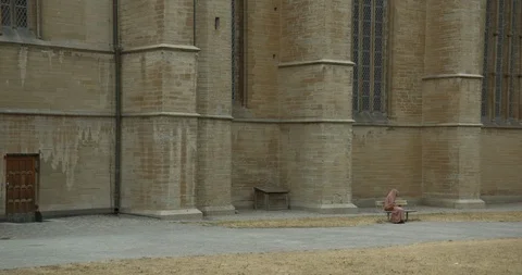 LINKÖPING, SWEDEN - AUGUST 4, 2018: A woman in a burqa in front of a big rustic Видео 95212427