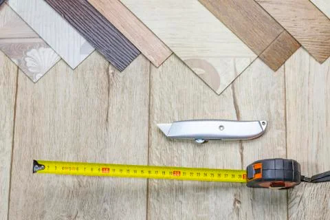 Linoleum close-up. Samples and tape measure and cutting knife. There is a tin Stock Photos