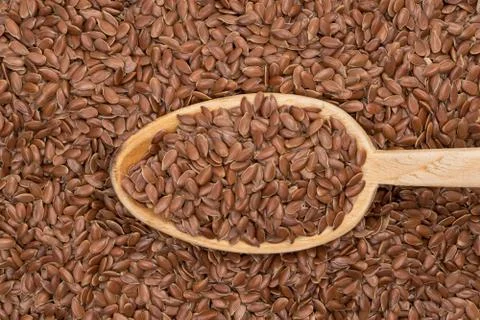 Linseed background and spoon Stock Photos