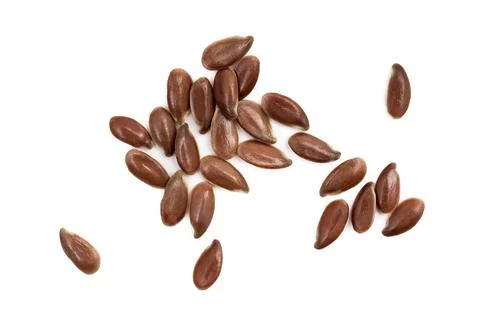 Linseeds spread on white background Stock Photos