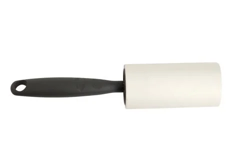 Lint roller with black handle isolated on white background. Sticky tool for.. Foto stock