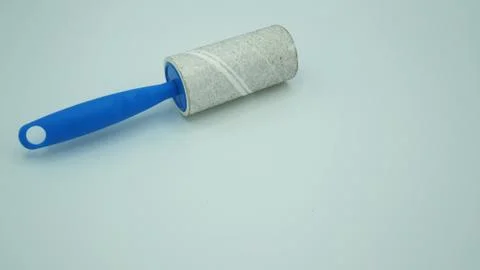 Lint roller full with dust isolated on white background. Stock Photos