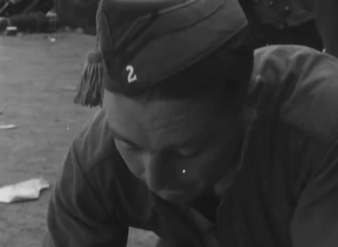 LINZ, AUSTRIA - 1945: Numeral two side cap - a man bows his head to write 스톡 동영상 344600176
