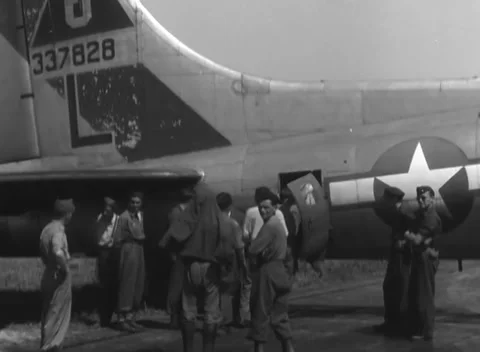 LINZ, AUSTRIA - 1945: Open gun position - men gather beneath the tail Stock Footage 344600150