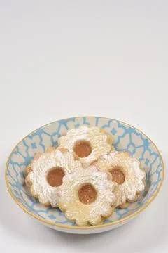 Linzer cookies on a blue patterned plate with copy space Stock Photos