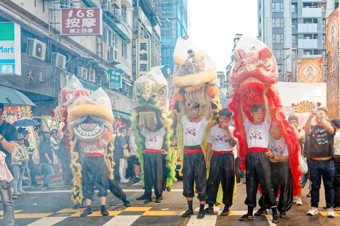 Lion Dance Troupe Performs Acrobatics Amid Smoke at City God Parade Stock Photos