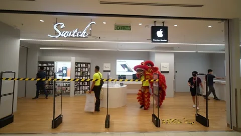 Lion dance walk in Switch outlet, premium reseller of Apple products Stock Footage