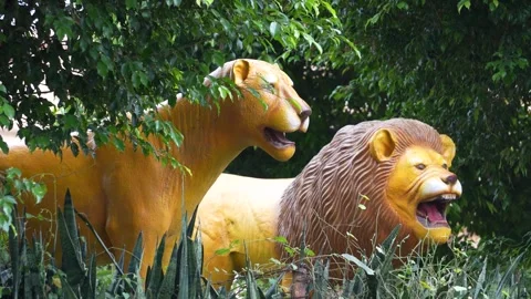 Lion Statue in Green Forest  Symbol of Power and Majesty Stock Footage 318617599