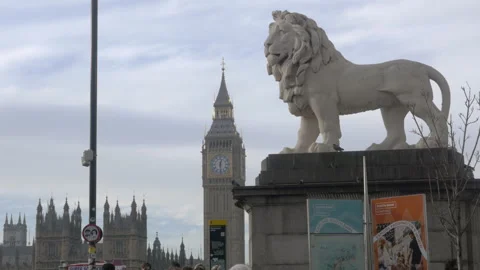 Lion Statue Overlooking Big Ben And Houses Of Parliament In London, UK Stock Footage 326027880