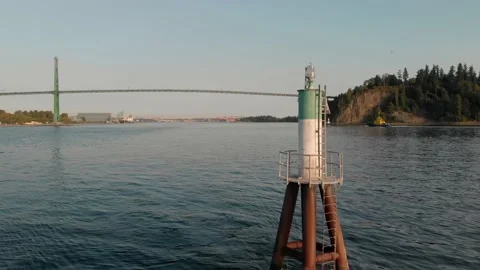 Lions Gate Bridge in Vancouver's harbor with pleasure craft passing by next to Stock Footage 140949447