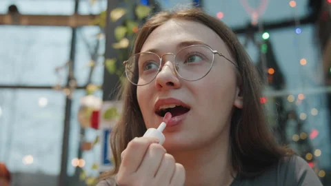 Lip gloss application. Intimate scene of applying pink lipstick softly. Close Stock Footage 335959870