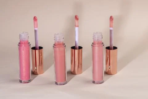 Lip gloss with applicator in light tubes. Cosmetic accessories. Фото