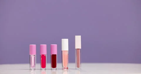 Lip gloss, empty and makeup in studio, beauty product and cosmetology on purple Stock Footage 318642249