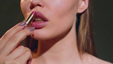 Lip makeup. Beautiful girl with beauty face, sexy full lips apply lipstick Stock Footage