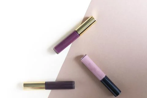 Lipgloss on a beige background 스톡 사진