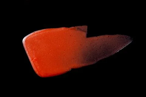 Lipgloss texture with black background Stock Photos