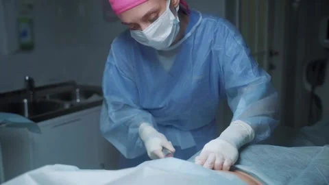 Liposuction procedure performed in a clinical setting by a skilled professional Stock-Footage 295864054
