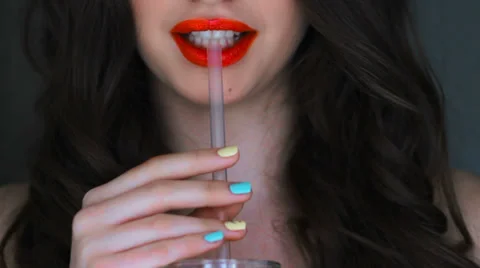Lips drink juice through a straw Stock Footage 36497785