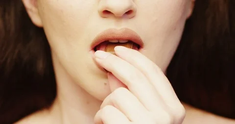 Lips Eating Chocolate Bar a close up of Woman Indulging in the Taste of Food Stock Footage 103322654