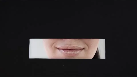 Lips the girl in a rectangular horizontal hole. Smile. Kiss. Stock Footage 86383199