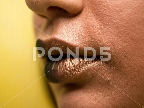 Lips make-up. Beauty high fashion trendy black with gold colour gradient lips Stock Photos