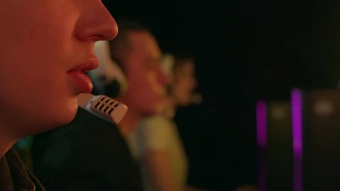 Lips of a man speaking into a microphone while playing a video game Stock Footage 151036471
