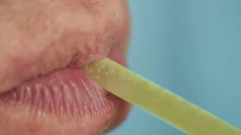 The lips of a man with a straw, drink the drink, close-up Stock Footage 143189122