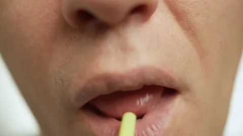 Lips of a young man drinking through a cocktail tube, close up Stock Footage 147986835