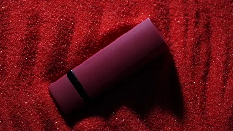 Lipstick lies in the red sand.  Stock Footage 140842285