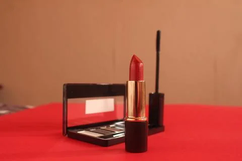 Lipstick on a red background with space for text copy space side angle. Beaut Stock Photos