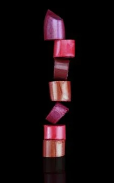 Lipstick stack on black background Stock Photos