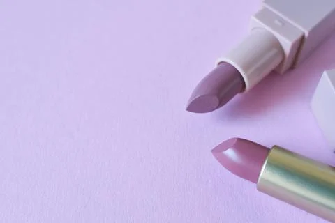 Lipsticks on a lilac background, close-up. Stock Photos
