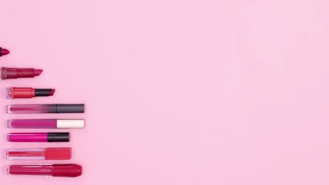 Lipsticks for make up appear on right side of pastel pink theme. Stop motion 스톡 동영상 158864028