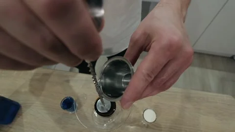 Liqueur flows over long cocktail spoon. Top view, slow motion, close up Stock Footage 131544758