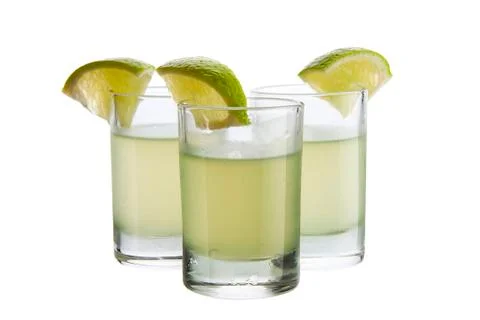 Liqueur with lime on white background Stock Photos