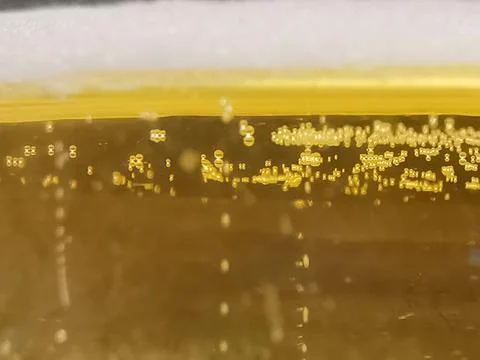 Liquid background with layers of yellow, white and bubbles with copy space Stock Photos