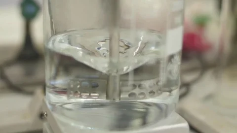 Liquid being mixed in laboratory glassware slow motion 4k Stock Footage 82731708